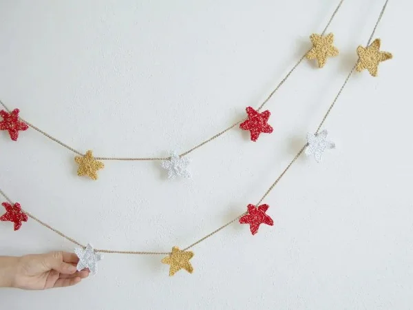 A crochet garland with red, white, and gold stars.