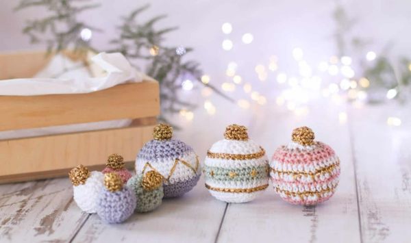 Crochet Christmas baubles with gold detail.