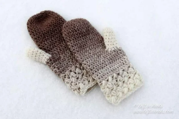 A pair of crochet mittens with a bean stitch cuff.