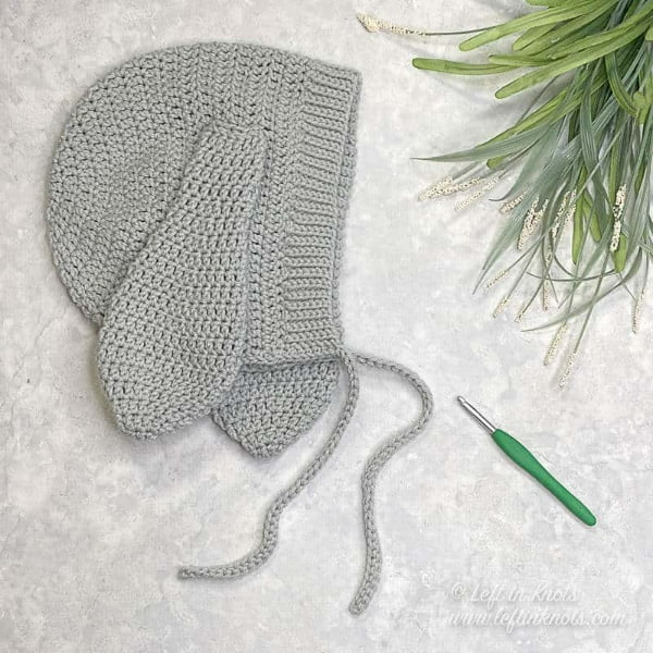 Crocheted bonnet with long bunny ears.