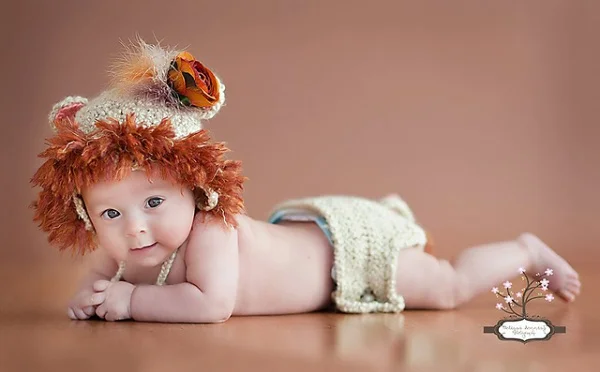 Baby wearing a crochet lion hat