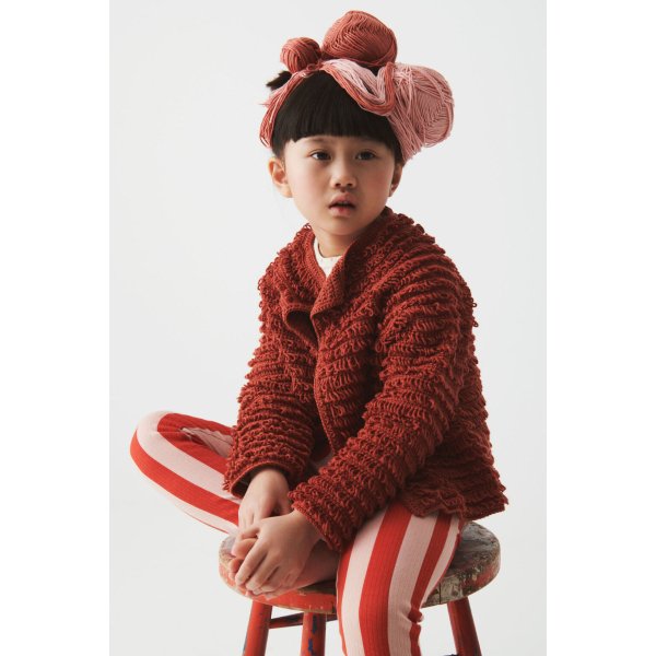 Red crochet children's cardigan featuring loop sttich.