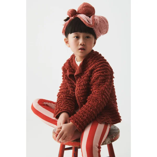 Red crochet children's cardigan featuring loop sttich.