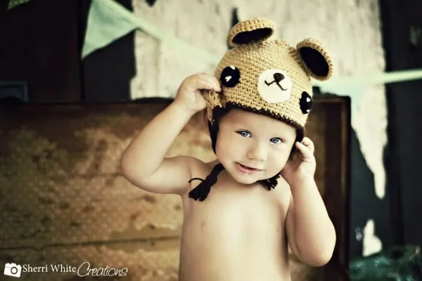 little boy wearing a crochet teddy bear hat