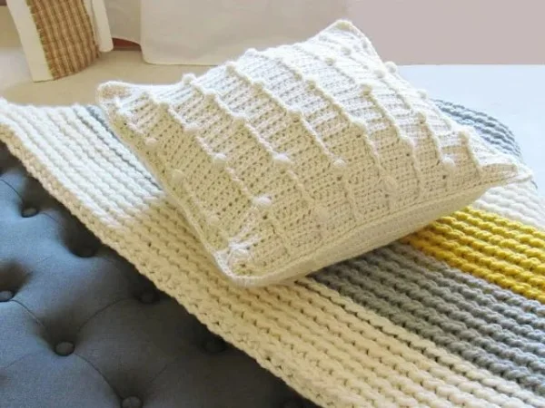 White bobble stitch crochet pillow.
