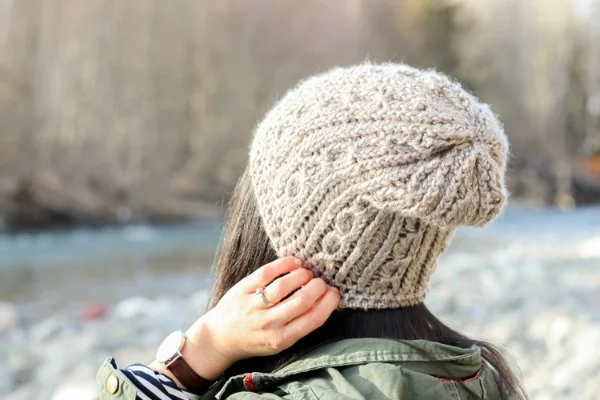 A woman wearing a crochet beanie.