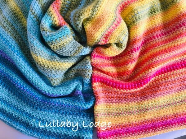 Brightly striped crochet blanket.