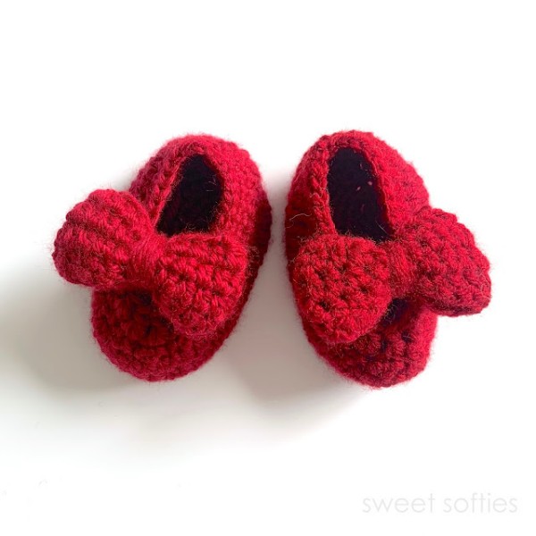 Crochet Mary Janes with red bows.