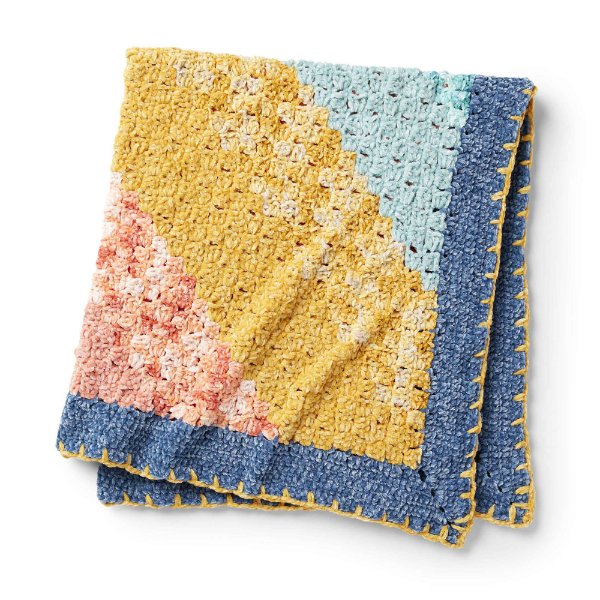 Folded crochet baby blanket.