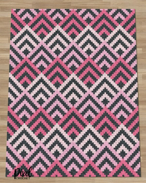 A crochet C2C blanket in pink and black.