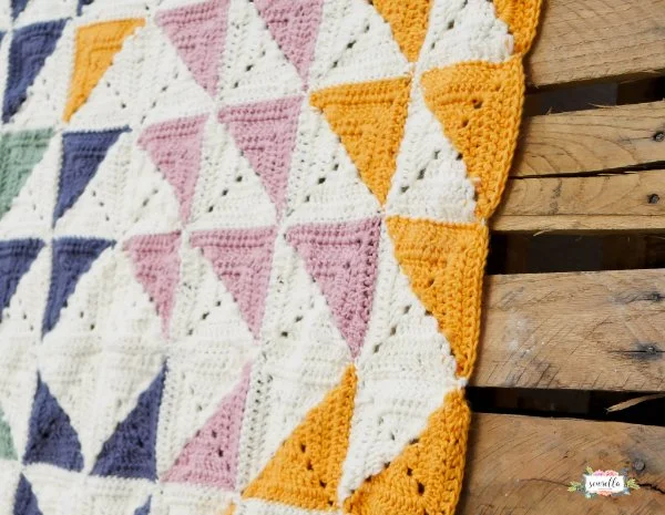 Crochet baby blanket featuring half-traingle squares.