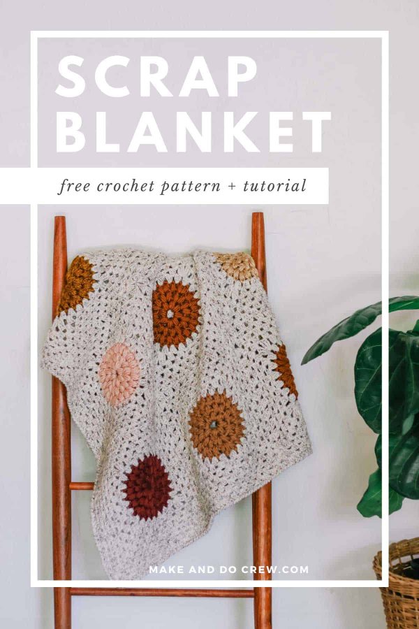 A crochet blanket hanging on a ladder next to a house plant.