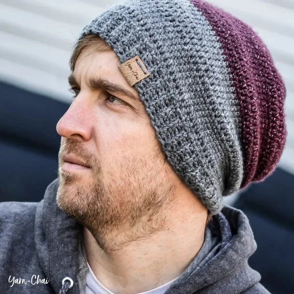 Side profile of a man wearing a crochet hat.