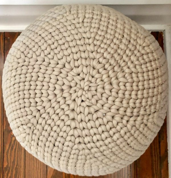Close-up of chunky crochet ottoman.
