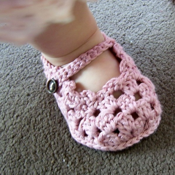 Pink granny-stitch crochet Mary Jane baby shoes.