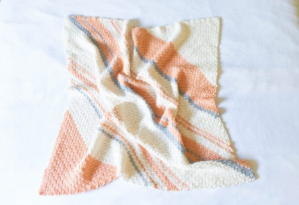 Pastel-striped crochet blanket.