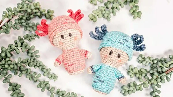 TWo crochet axolotl dolls., one blue and one pink.