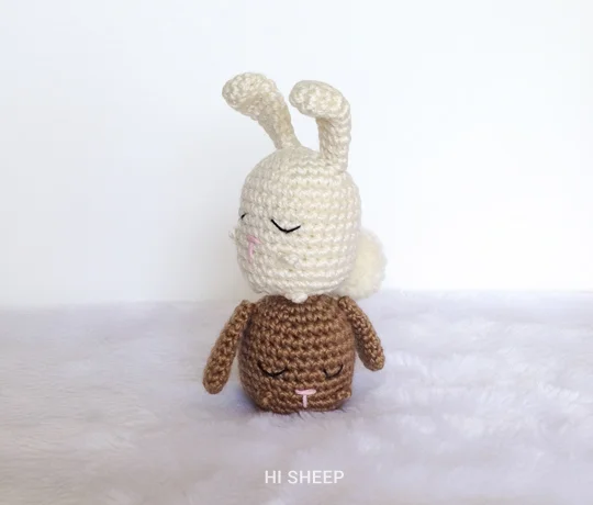 Two crochet rabbits, one on top of the other.