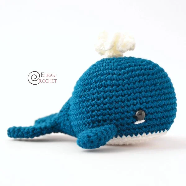 A blue and white amigurumi crochet whale.