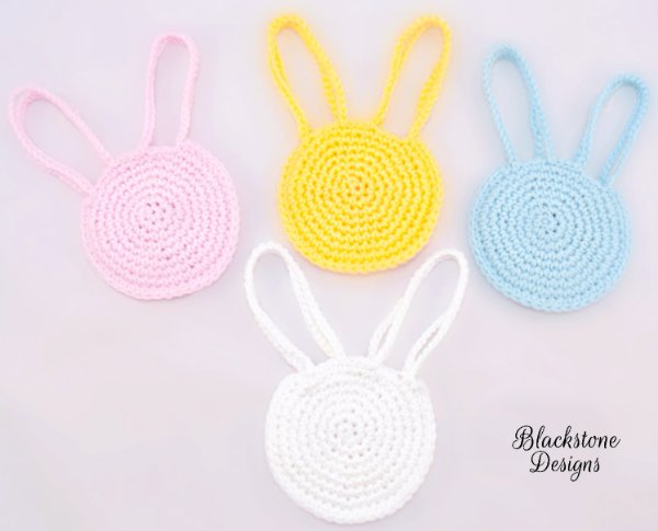 Crochet Easter bags in four pastel colours.