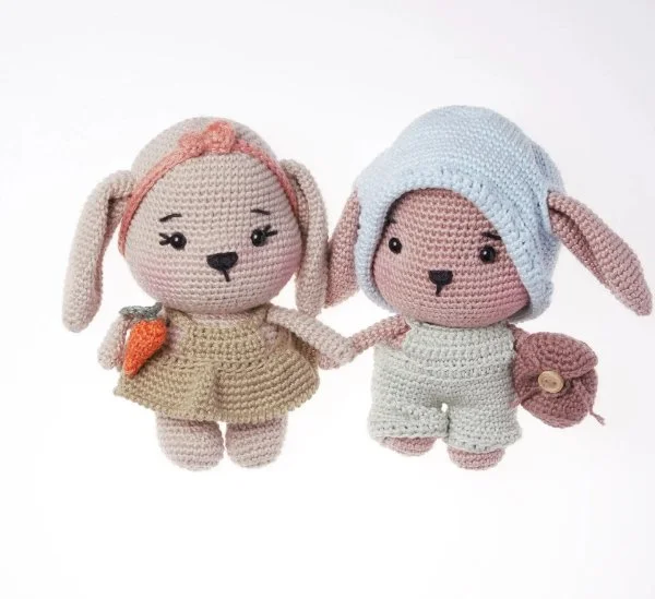Boy and girl amigurumi bunnies holding hands.