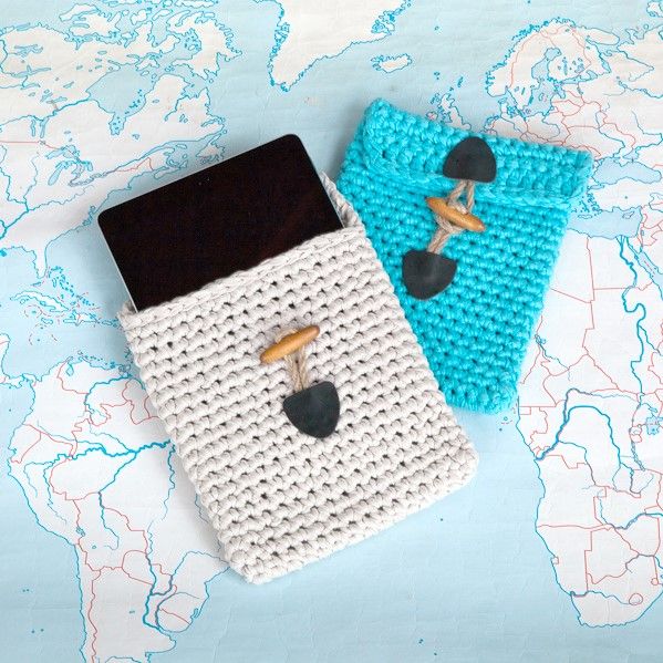 Two crochet iPad cases with toggle detail on a map background.