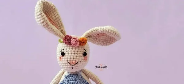 An amigurumi rabbit with a flower crown.