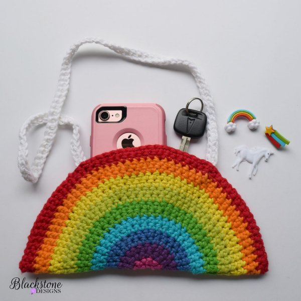 A rainbow crochet bag with phone and keys.