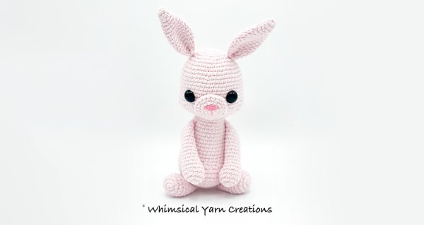 A pink amigurumi rabbit.