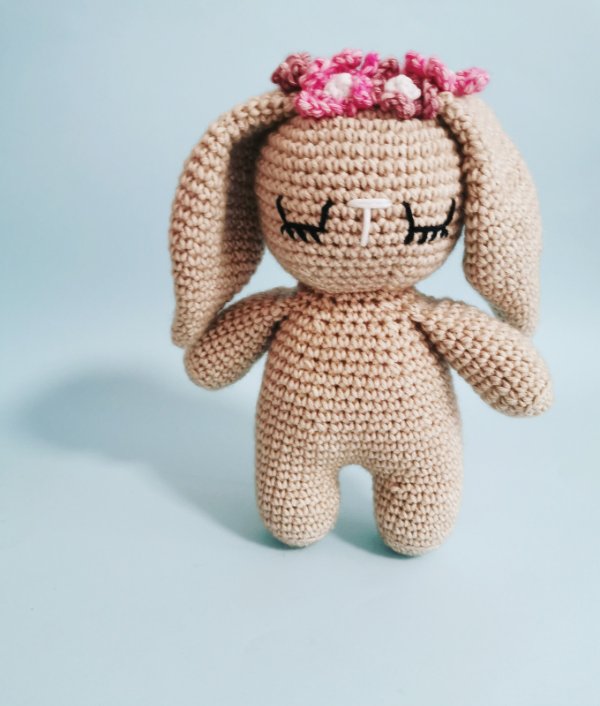A crochet bunny wearing a flower crown.