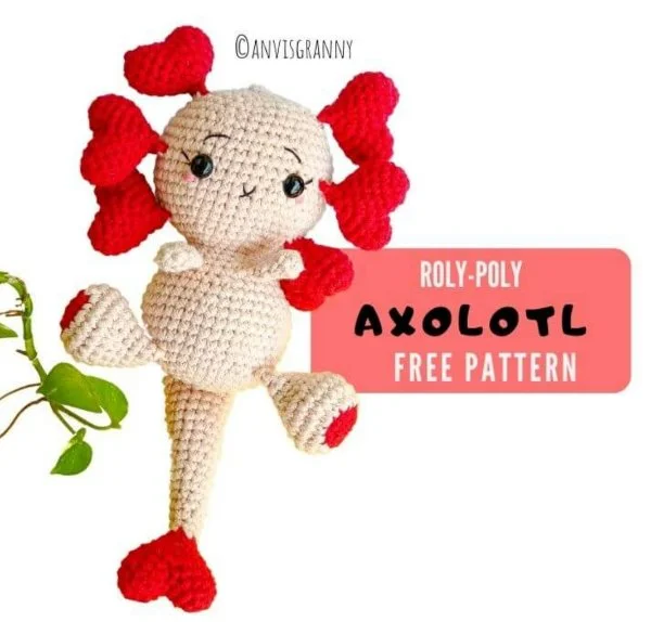 A red and white crochet axolotl with Valentine's day hearts.