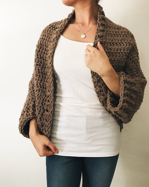 A brown crochet shrug made with chunky weight yarn.