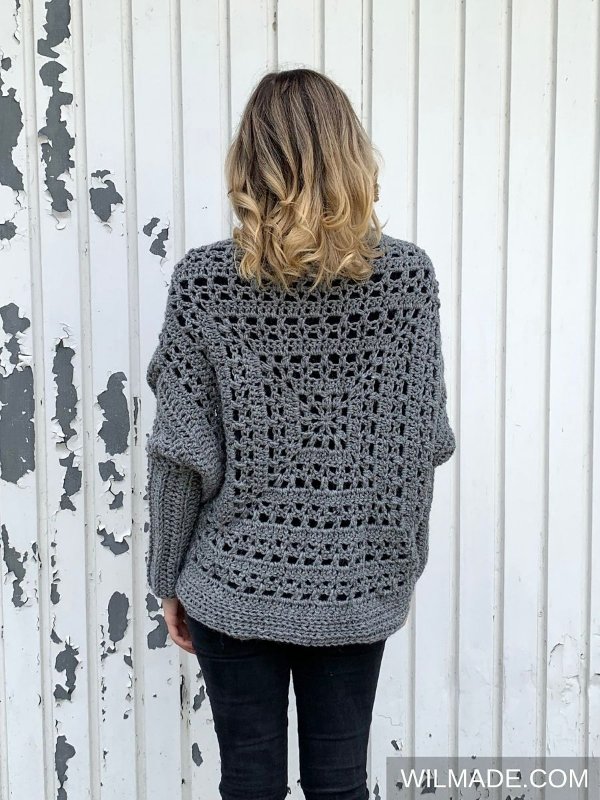 Back view of woman wearing a grey crochet shrug.