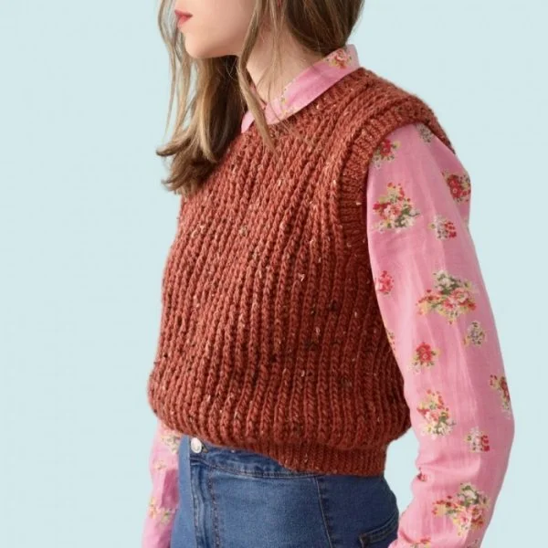 A side view of a woman with a rib-look crochet sweater vest.