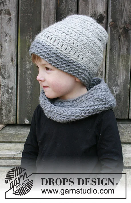 A child with a two-toned grey crochet cowl and beanie set.
