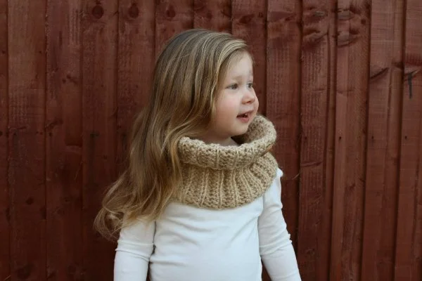 A child wearing a ribbed crochet cowl.