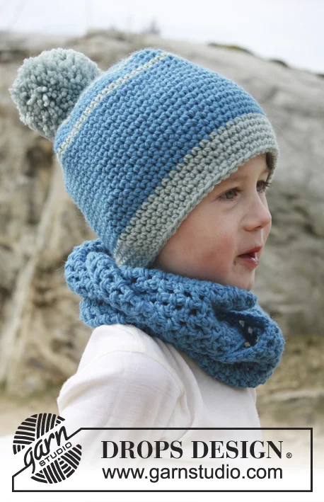 A boy with a matching blue crochet beanie and cowl.