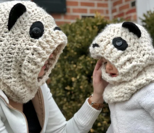 A woman and child with matching crochet panda cowls.