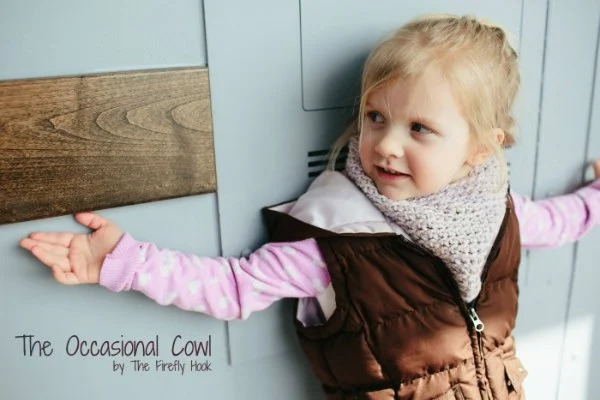 A child with a warm crochet cowl.