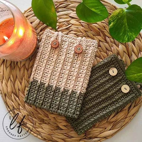 Two crochet kindle covers on a seagrass mat.