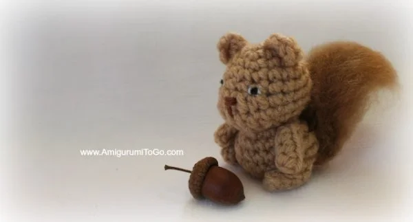 A tiny crochet squirrel and an acorn.