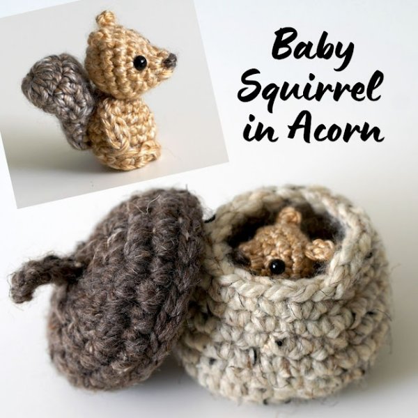 A baby crochet squirrel hiding inside a crochet acorn.