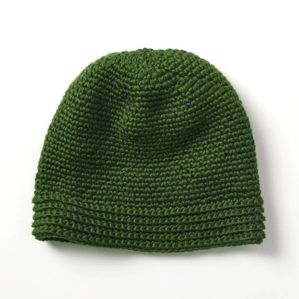 A green men's crochet hat on a white background.