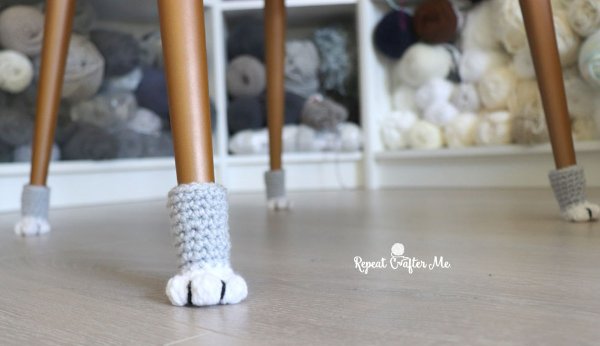 Grey and white crochet cat paw chair socks.