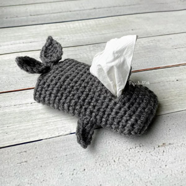 A grey whale shaped crochet pocket tissue holder.