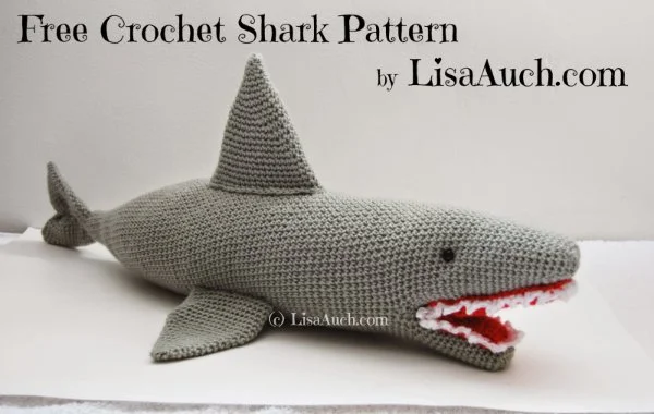 A large crochet shark with red mouth and teeth showing.