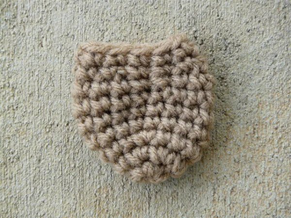 A brown crochet chair sock.