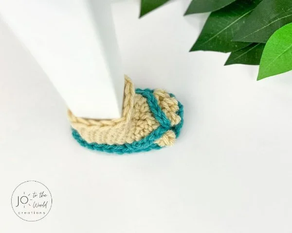 Crochet chair socks in the shape of flip flops.