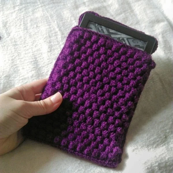 A purple crochet Kindle case.