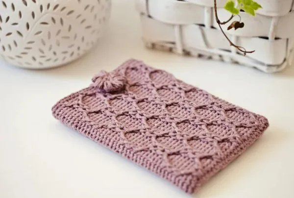 A pink crochet cable stitch Kindle cover.